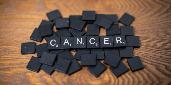 cancer spelled out in scrabble tiles