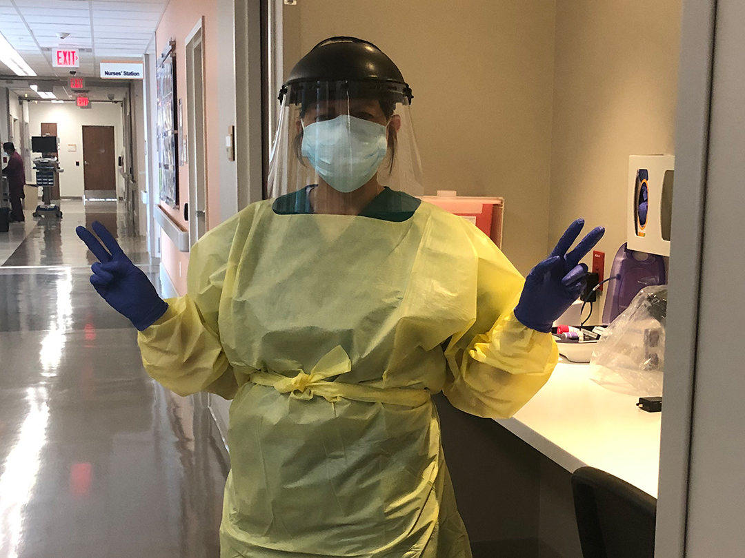 Adriana Munoz stands covered in personal protective equipment at University Hospital