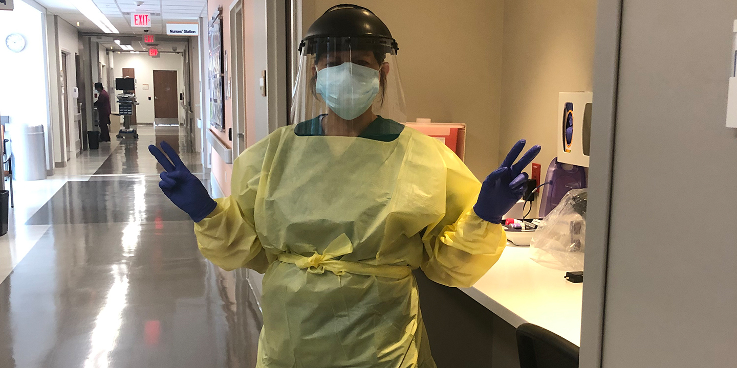 Adriana Munoz stands covered in personal protective equipment at University Hospital