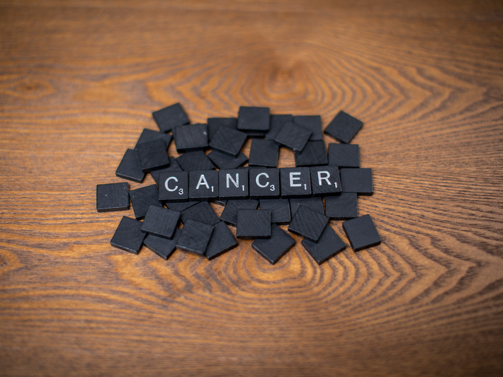 Cancer spelled out in Scrabble tiles.